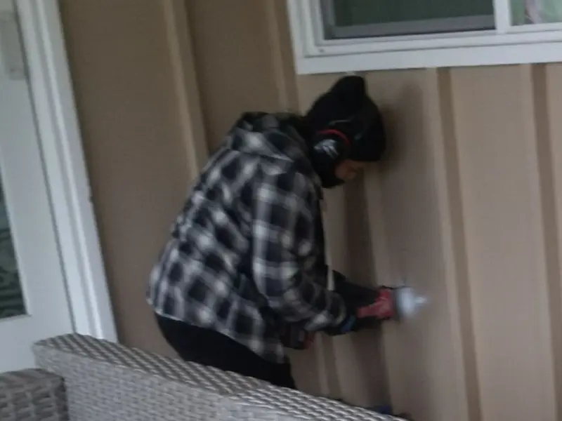 Professional electrician installing an exterior outlet in Ankeny